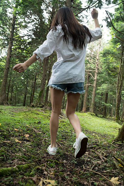 istock From behind the girl in the woods. 594931274