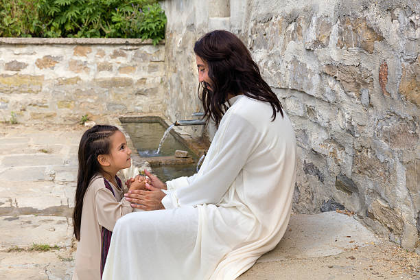Jesus praying with a little girl stock photo