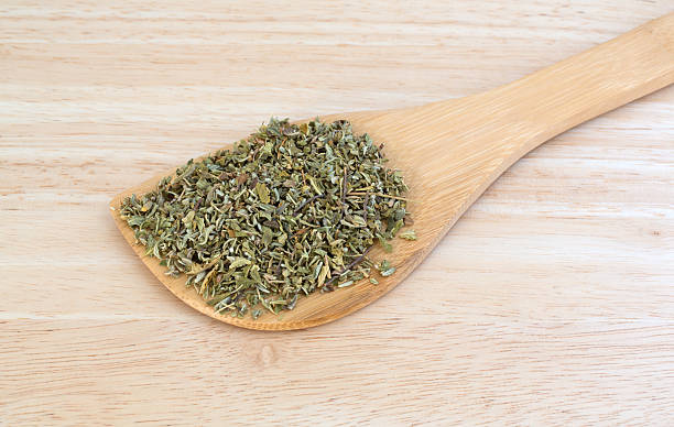 istock Portion of damiana leaf on a wood spoon 594931896