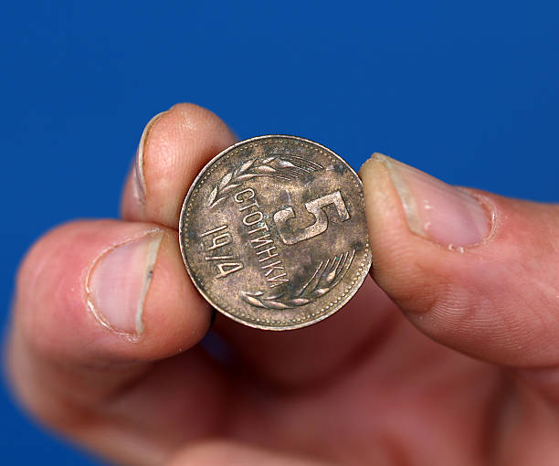 istock Fingers hold old coin from bulgaria 594933538