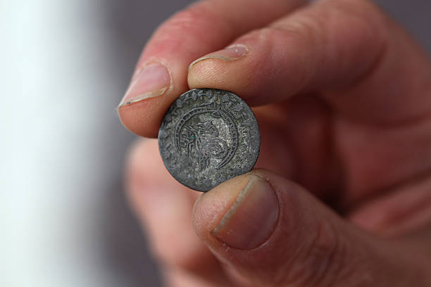 istock Fingers hold old coin from Ottoman empire 594934028