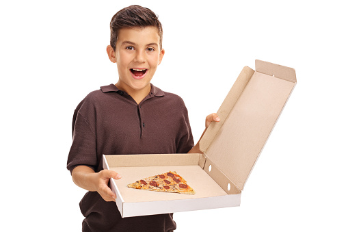 Excited boy holding a pizza box with a single slice isolated on white background