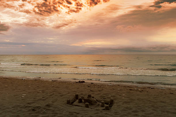 istock Sunrise on the beach and sandcastle 594936892