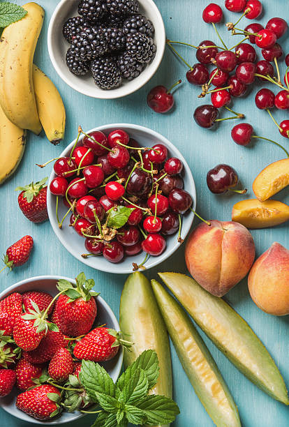 istock Healthy summer fruit variety on blue wooden backdrop 594937476