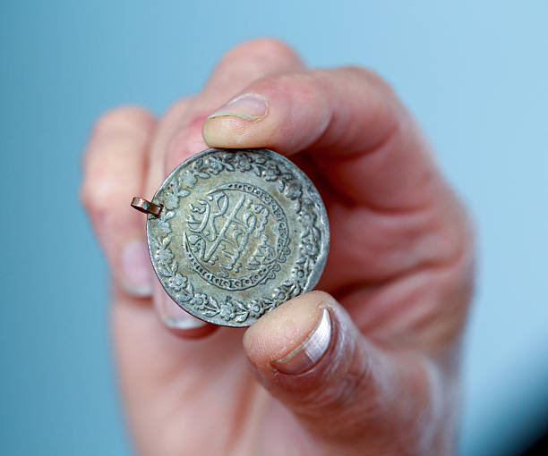 istock Fingers hold old coin from Ottoman empire 594938172