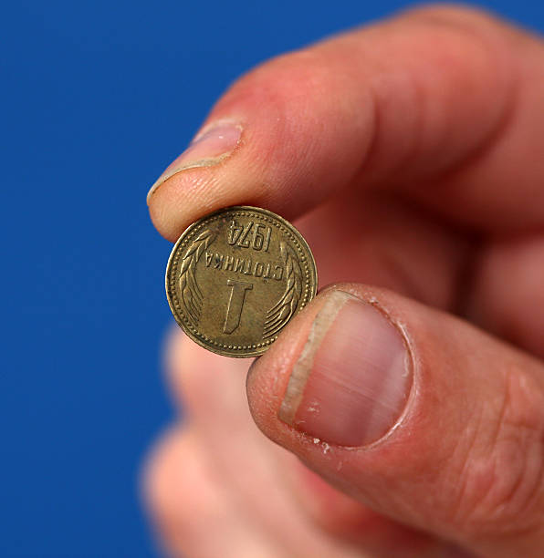 istock Fingers hold old coin from Bulgaria 594938458