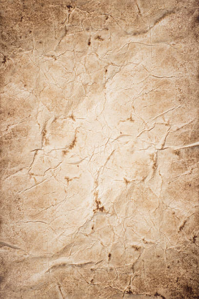istock Piece of old rumpled stained paper as background 594940126