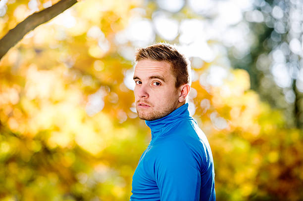 istock Young handsome hipster runner outside in sunny autumn nature 594942192