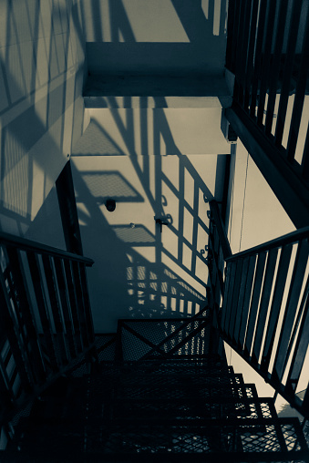 Metal staircase with shadows