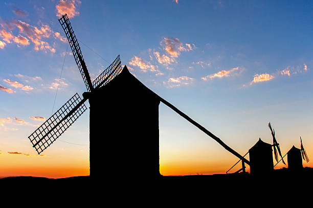 istock Silhouette of Spanish windmills at sunset 594943192