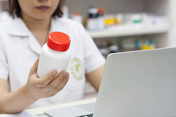 istock Pharmacist holding medication in the pharmacy 594944664