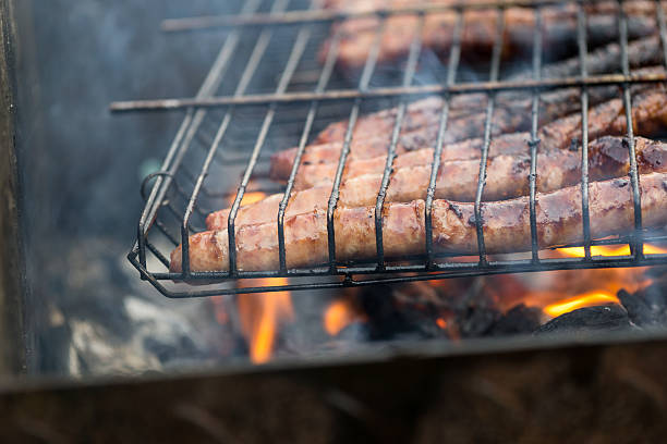 istock BBQ grill with fried sausages on coals 594944974