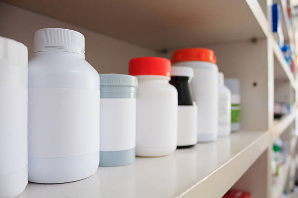 istock medicine bottles arranged on shelf at drugstore 594945314