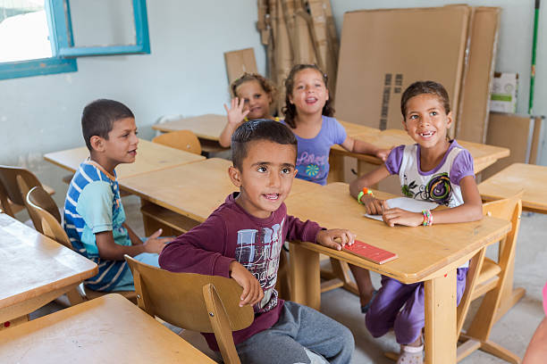 Lagadikia, Greece - August 25, 2016: Children sit in a classroom in the refugee camp of Lagadikia, some 40km North of Thessaloniki, during the visit of UN high commissioner for refugees Filippo Grandi