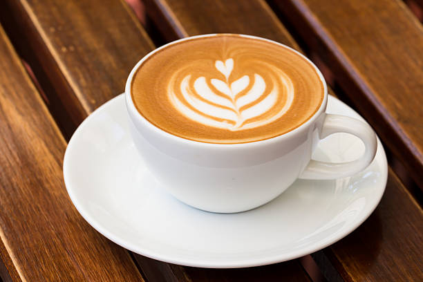 istock Hot art Latte Coffee in a cup on wooden table 594949366
