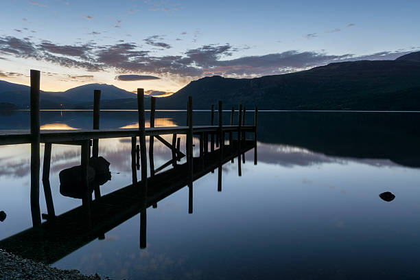 istock Dawn Silhouette At Lake With Jetty. 594952102