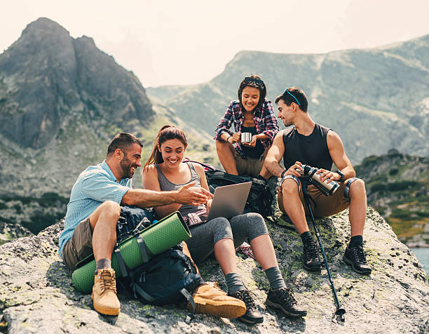 istock Friends browsing the net in the mountain 594954750