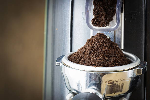 istock coffee grinder grinding freshly roasted coffee beans into a coff 594954890