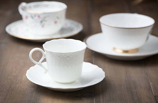 istock white cup of coffee on wood background 595097190