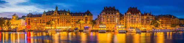 istock Stockholm Strandvagan harbour waterfront illuminated at dusk panorama Sweden 595103096