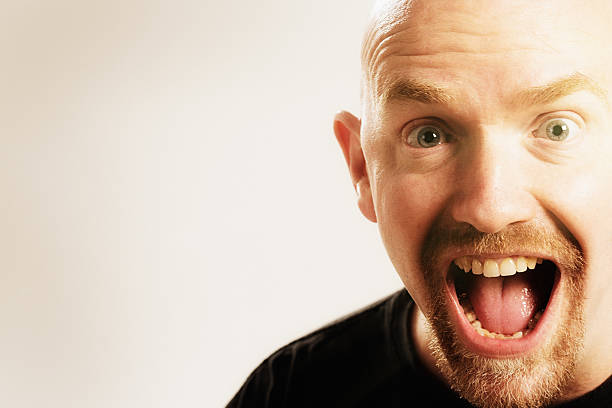 istock Laughing, surprised and delighted mature man gasps 595103466