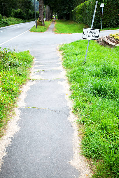 istock Damaged sidewalk at road in valley Ruhr 595107064