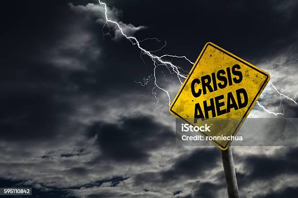 Crisis Ahead Sign With Stormy Background Stock Photo - Download Image Now - Crisis, Despair, Accidents and Disasters