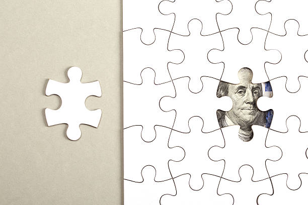 istock Collecting dollar banknote with jigsaw puzzle 595118154