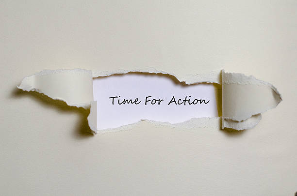 istock The word time for action appearing behind torn paper 595137162
