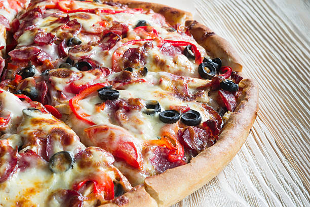 istock pizza closeup on wood 595137662