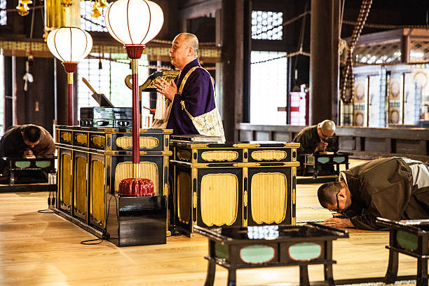 istock Buddhist monks praying in early morning inside a Temple 595137672