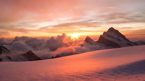 dawn in the Fieschersattel with the sun rising over the Finsteraarhorn ion the Bernese Highlands in the Swiss Alps