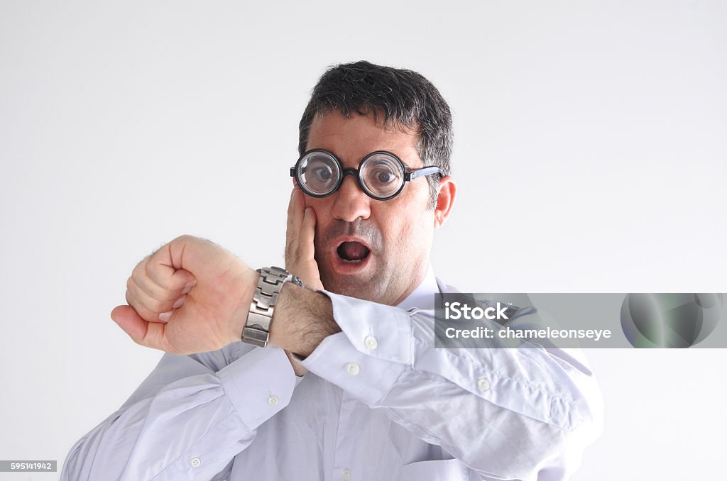 Surprised late man watching the time on his watch Surprised late man watching the time on his watch.   Business and relationship concept. real people copy space on white background Adult Stock Photo