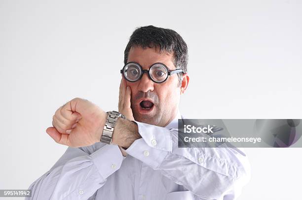 Surprised Late Man Watching The Time On His Watch Stock Photo - Download Image Now - Adult, Business, Business Finance and Industry