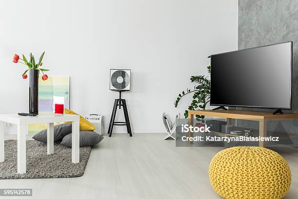 Airy Interior For Enthusiasts Of Good Movies Stock Photo - Download Image Now - Television Set, Coffee Table, Hassock