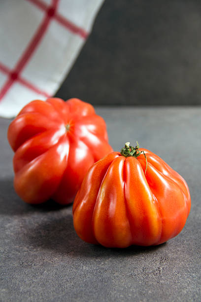 istock Buffalo heart tomatoes, gray background, close up. 595147258
