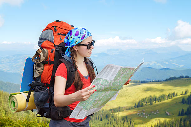 istock Woman hiker in mountains read the map 595150652