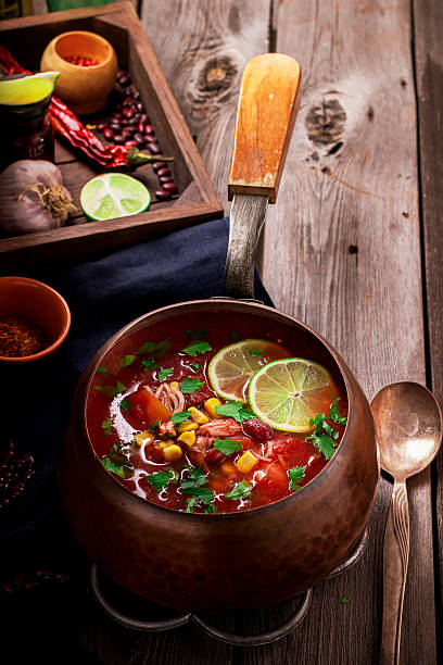 istock Tomatoe mexican soup with spices and lime on wooden table 595151420