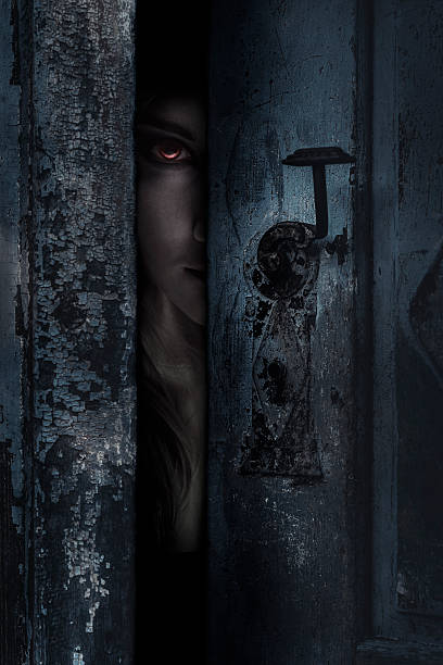 Vampire Vampire looking through a hole. Halloween theme.  vampire woman stock pictures, royalty-free photos & images