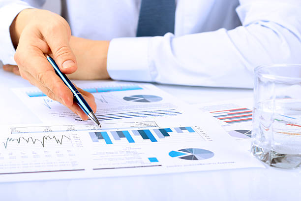 istock young businessman showing graphs by pen 595154210