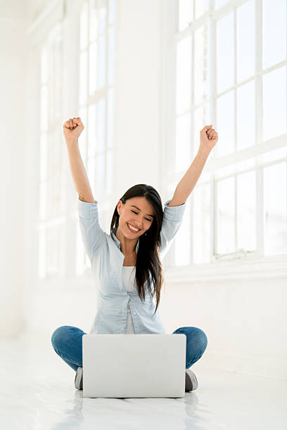 istock Excited woman working on a laptop from home 595155420