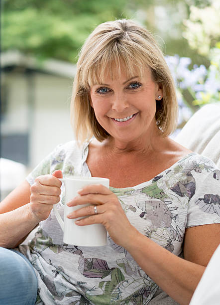 istock Woman relaxing at home and drinking coffee 595155522