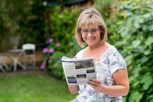 Senior woman reading the newspaper