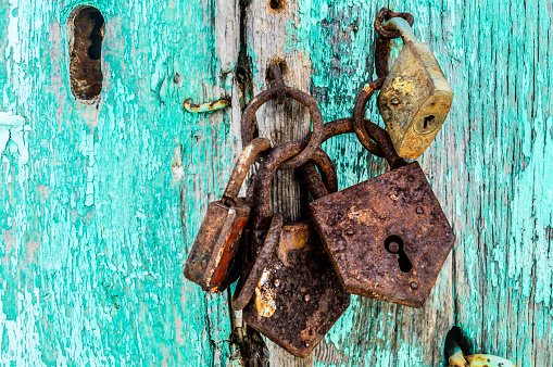 Padlock with green wooden background