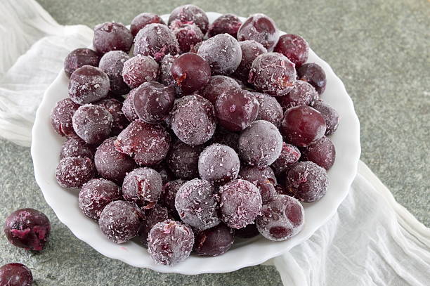 Frozen grapes in a white bowl Frozen grapes served in a white bowl frozen grapes stock pictures, royalty-free photos & images