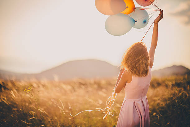 istock Girl walking in wheat field 595157954