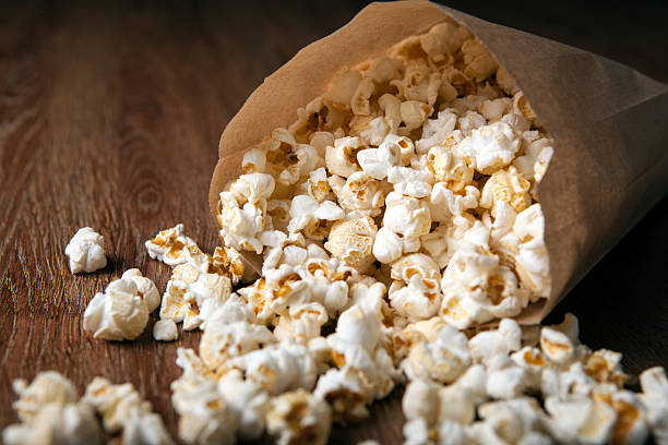 istock salted popcorn in a paper bag on a wooden table 595158978