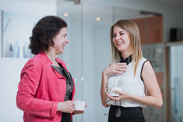 istock colleagues in the office talking during the coffee break 595159614