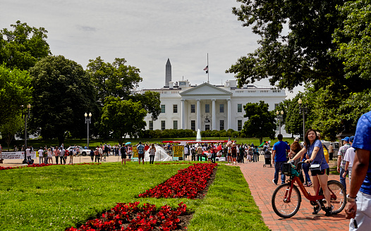 Washington DC, USA - May 30, 2016: Demonstrators and Tourists on the road in front of the White House and at Presidents Park
