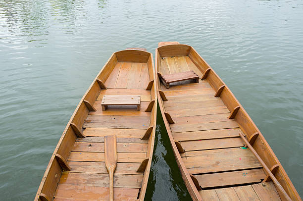 Old wooden row boat on water